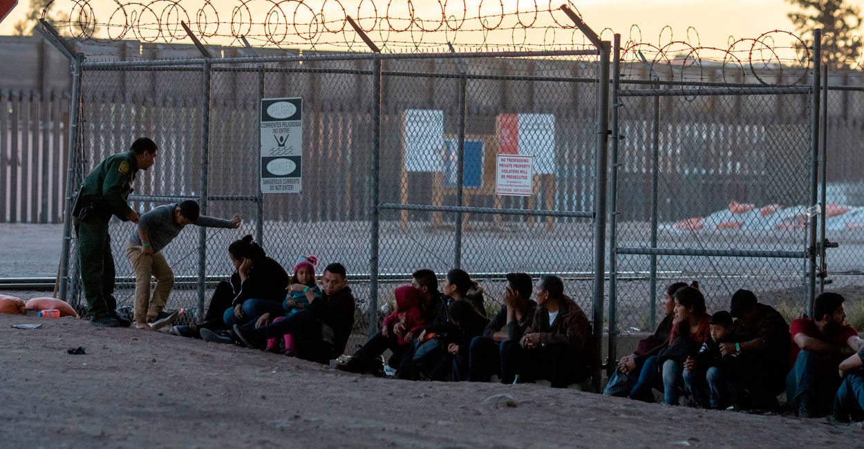 U.S. Border Patrol agents detain and process a group of migrants near the P...