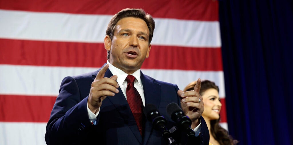 Ron DeSantis speaks in front of an American flag