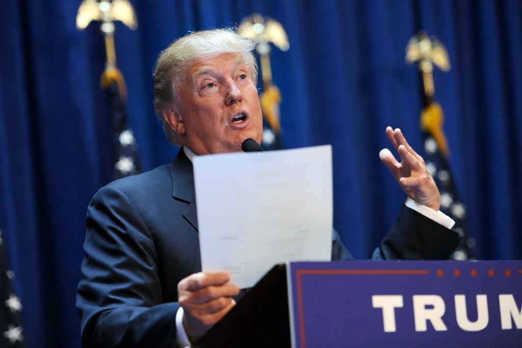Donald Trump holds up a statement of his net worth after declaring his candidacy for president. (Photo: Anthony Behar/ Sipa USA/Newscom)