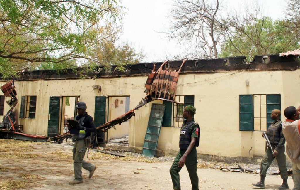 Police officers walk past the Chibok school where more than 200 schoolgirls have been abducted by Boko Haram Islamists on April 21, 2014. (Photo: AFP/Getty Images/Newscom)